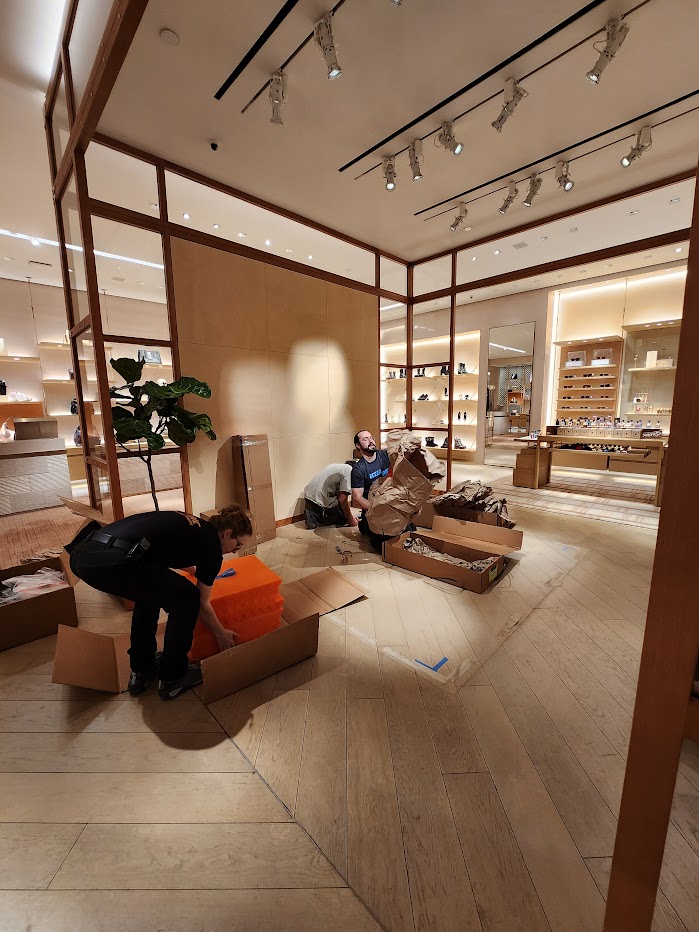 Installation crew preparing materials inside Louis Vuitton store