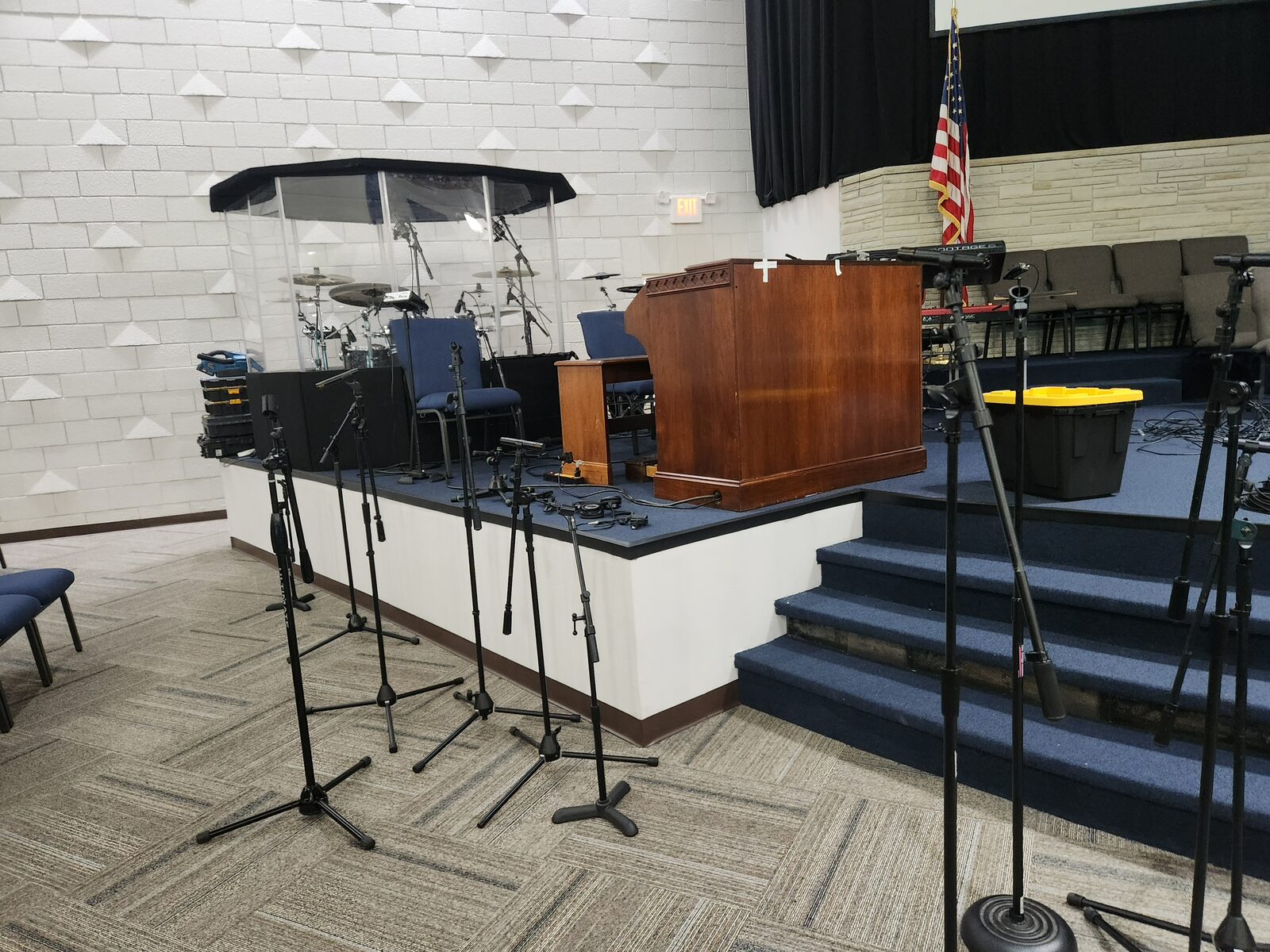 Mt. Gilead sanctuary stage with blue broadloom carpet, cross, projection screens, and communion table — Nashville