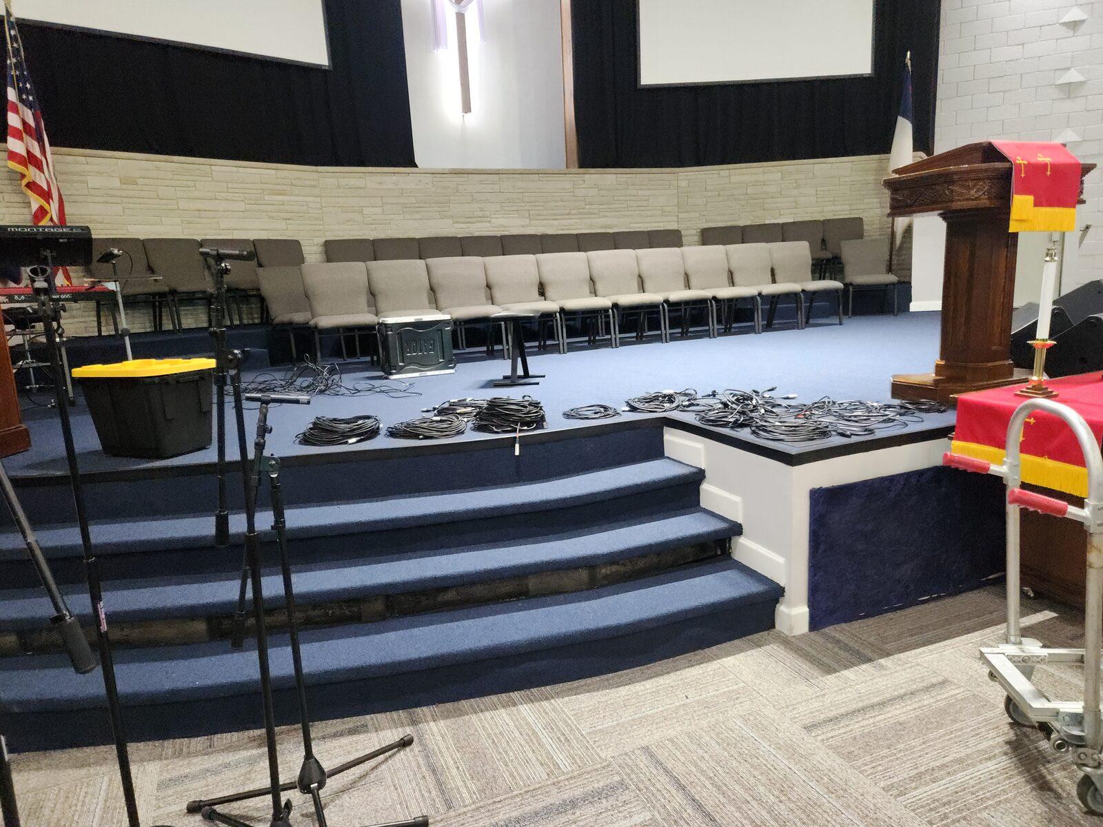 Mt. Gilead sanctuary stage detail — blue broadloom on steps, podium, choir seating, and masonry wall — Nashville