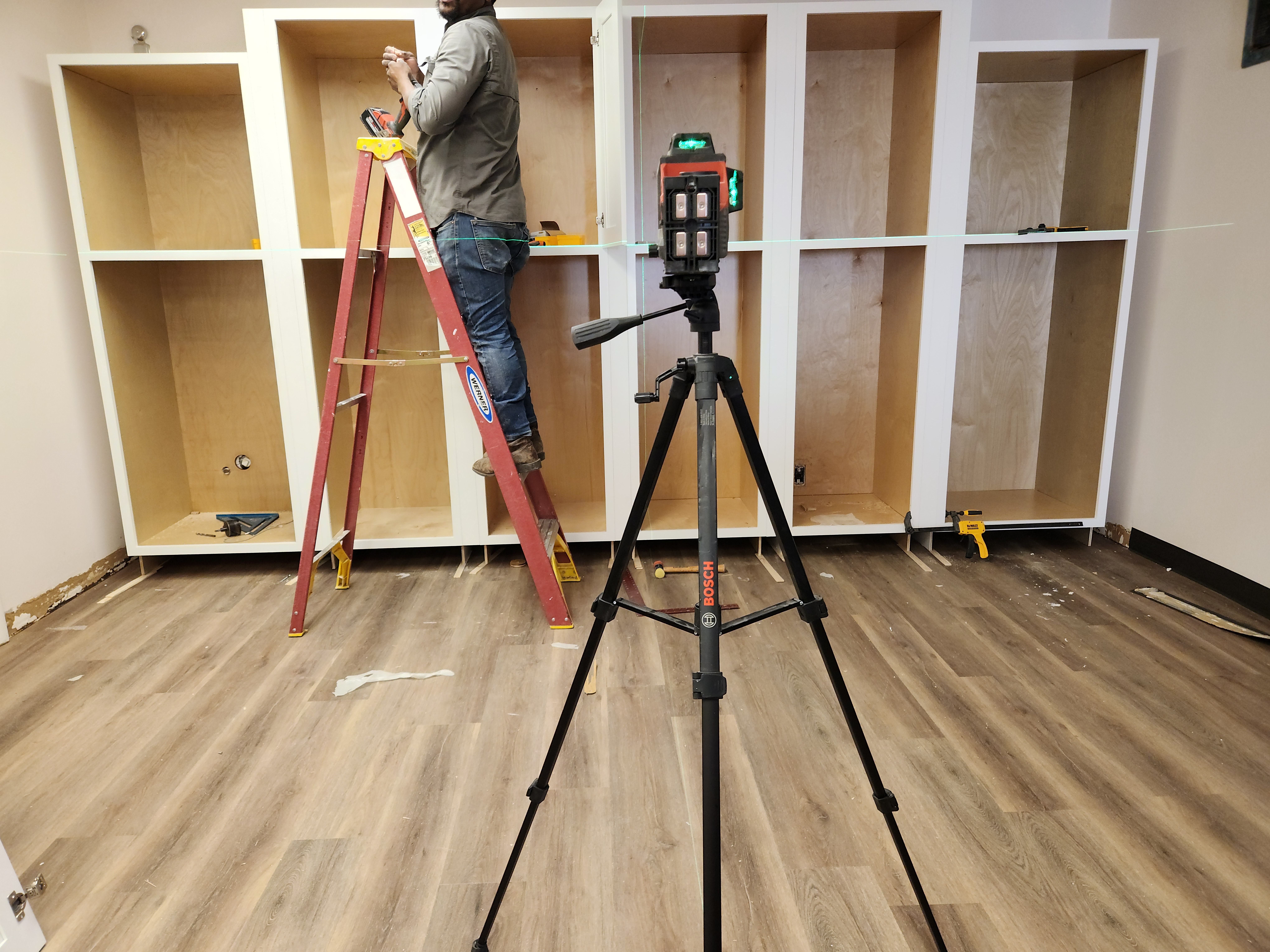 Bosch laser level and cabinet installation over new LVP flooring at SEIU Local 205 — Nashville