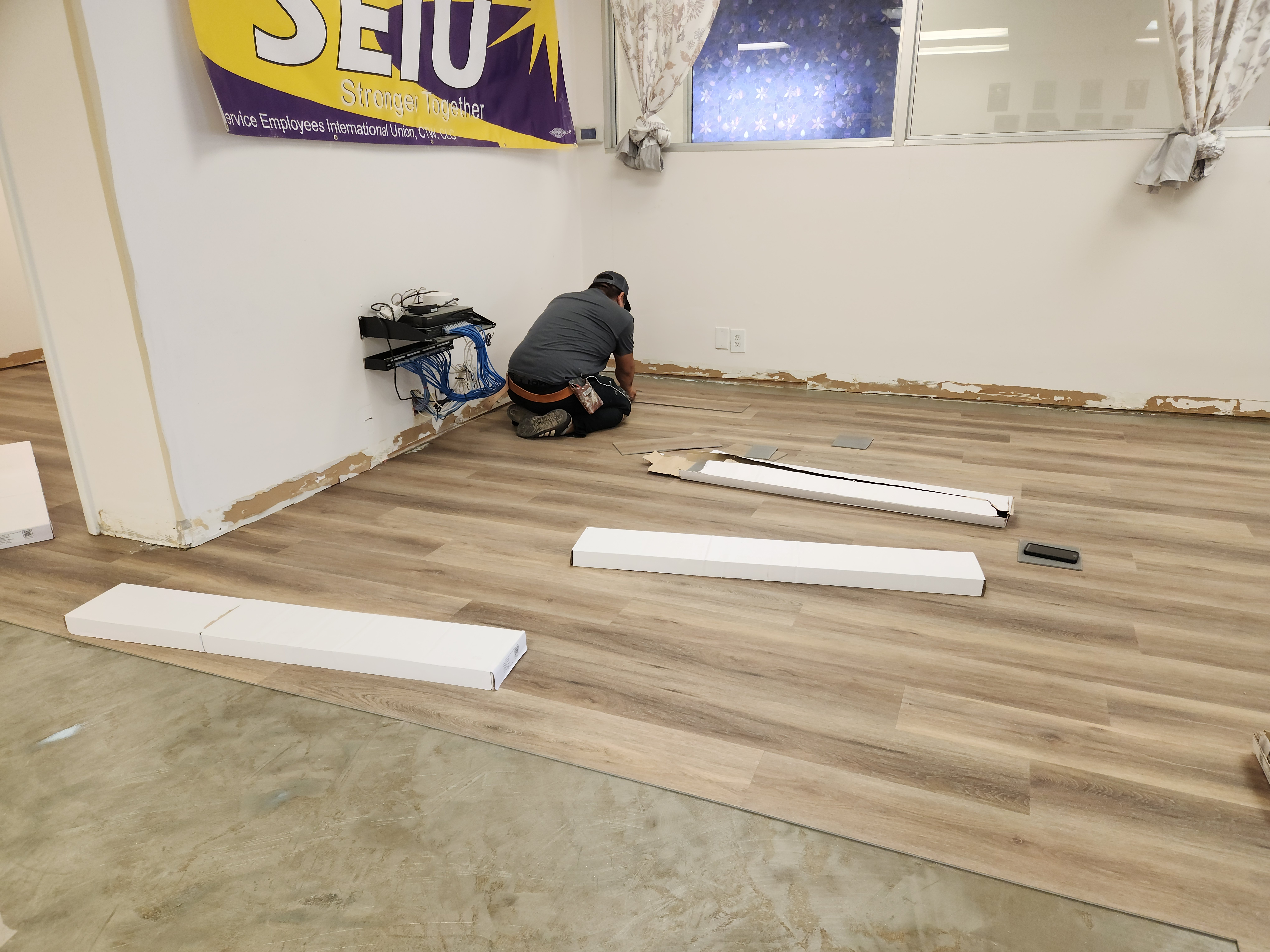180 Degree Floors crew member installing LVP planks at SEIU Local 205 office — Nashville