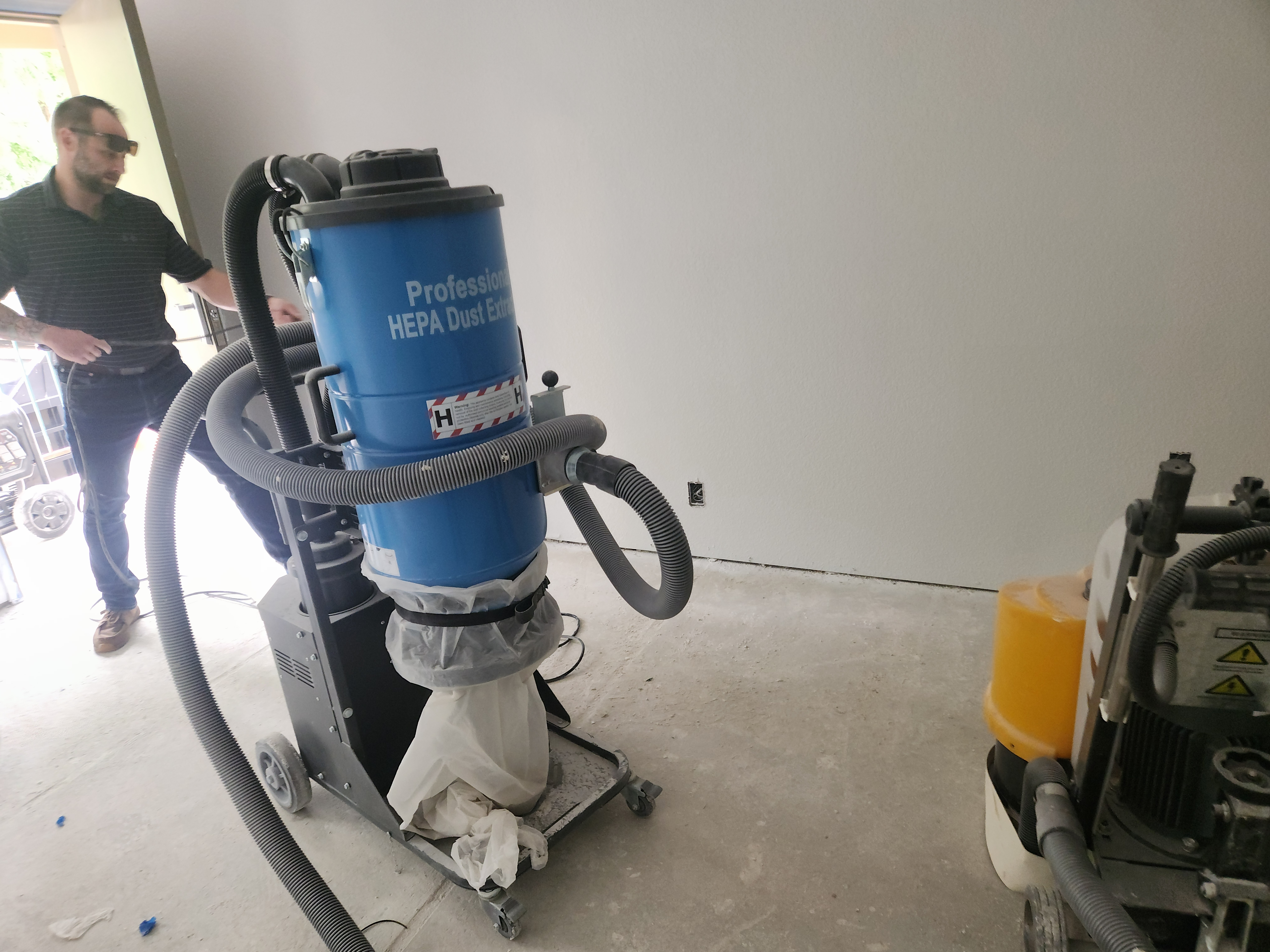 Professional HEPA dust extractor on-site during commercial concrete grinding — 180 Degree Floors, Nashville